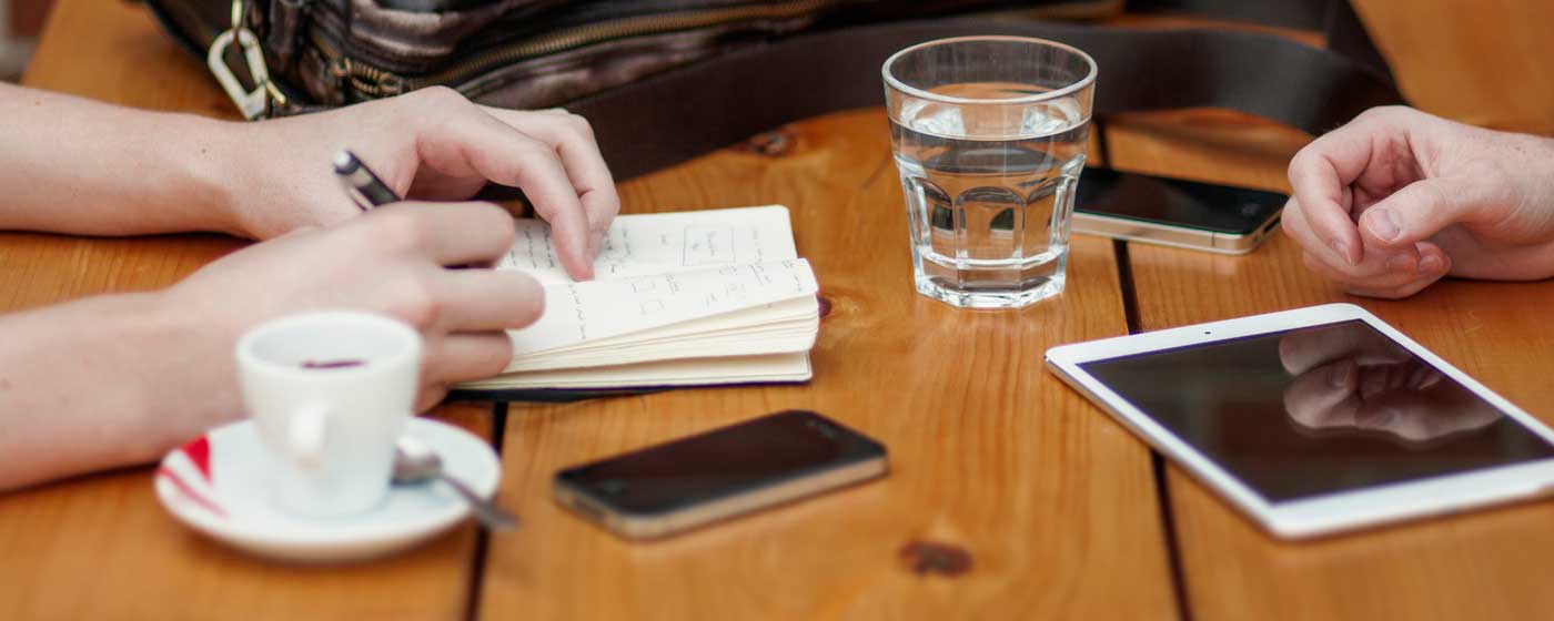 Photo of two business partners looking at their paid online ad campaign on an iPad.