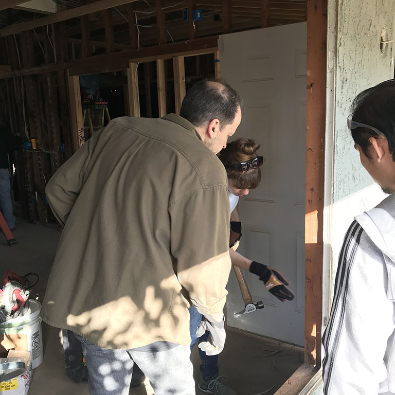 Ed and Alex help install a window with Dinh
