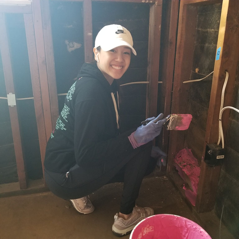 Lyna Vu painting the walls