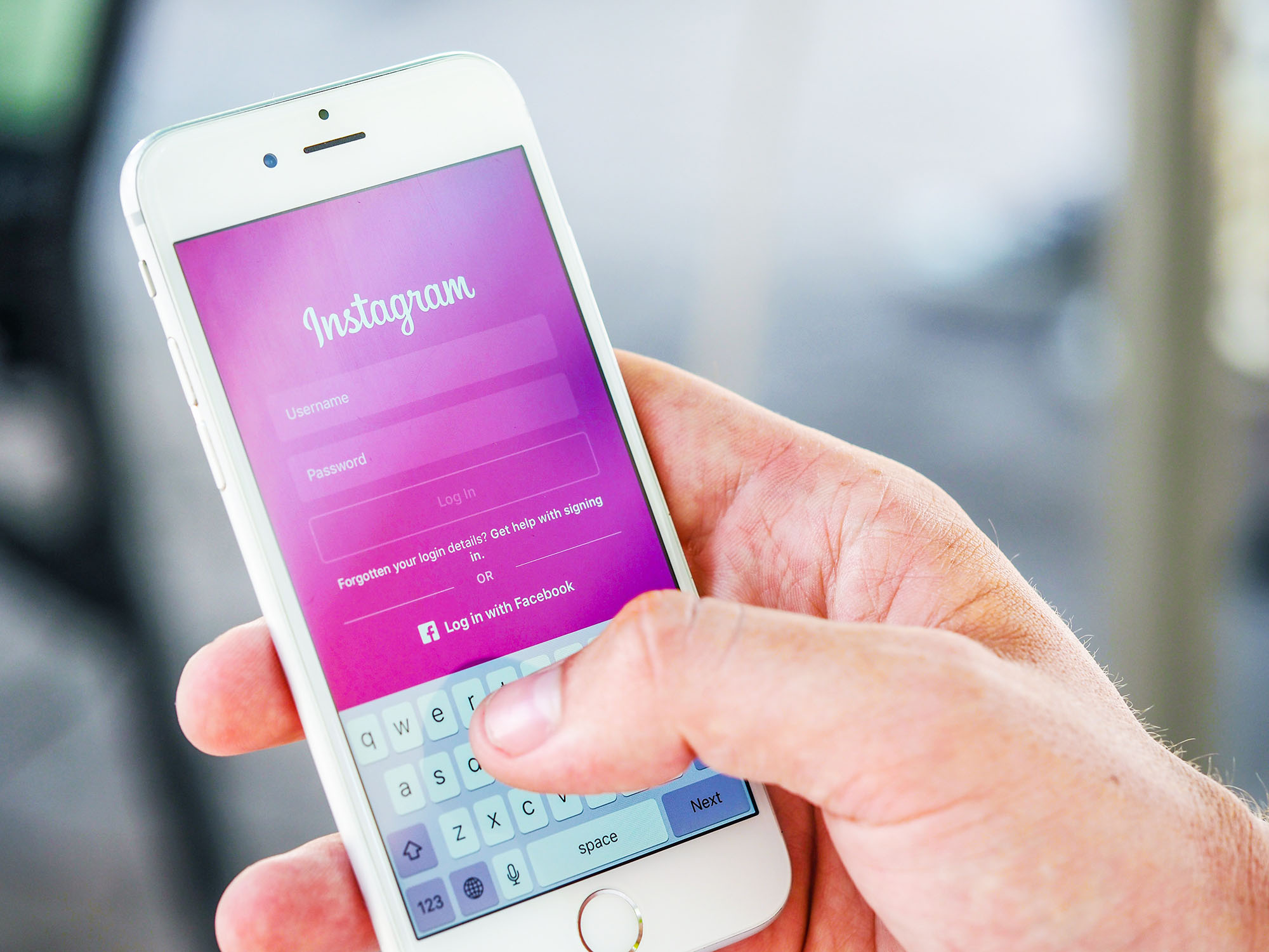 Photo of someone holding a smart phone about to log into Instagram
