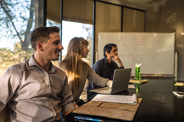 Two SEO user experience experts from the CTS team work at their computers